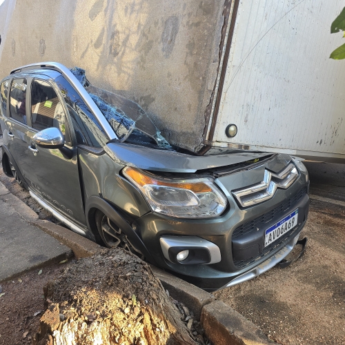 Automóvel fica destruído após carreta tombar e cair sobre automóvel